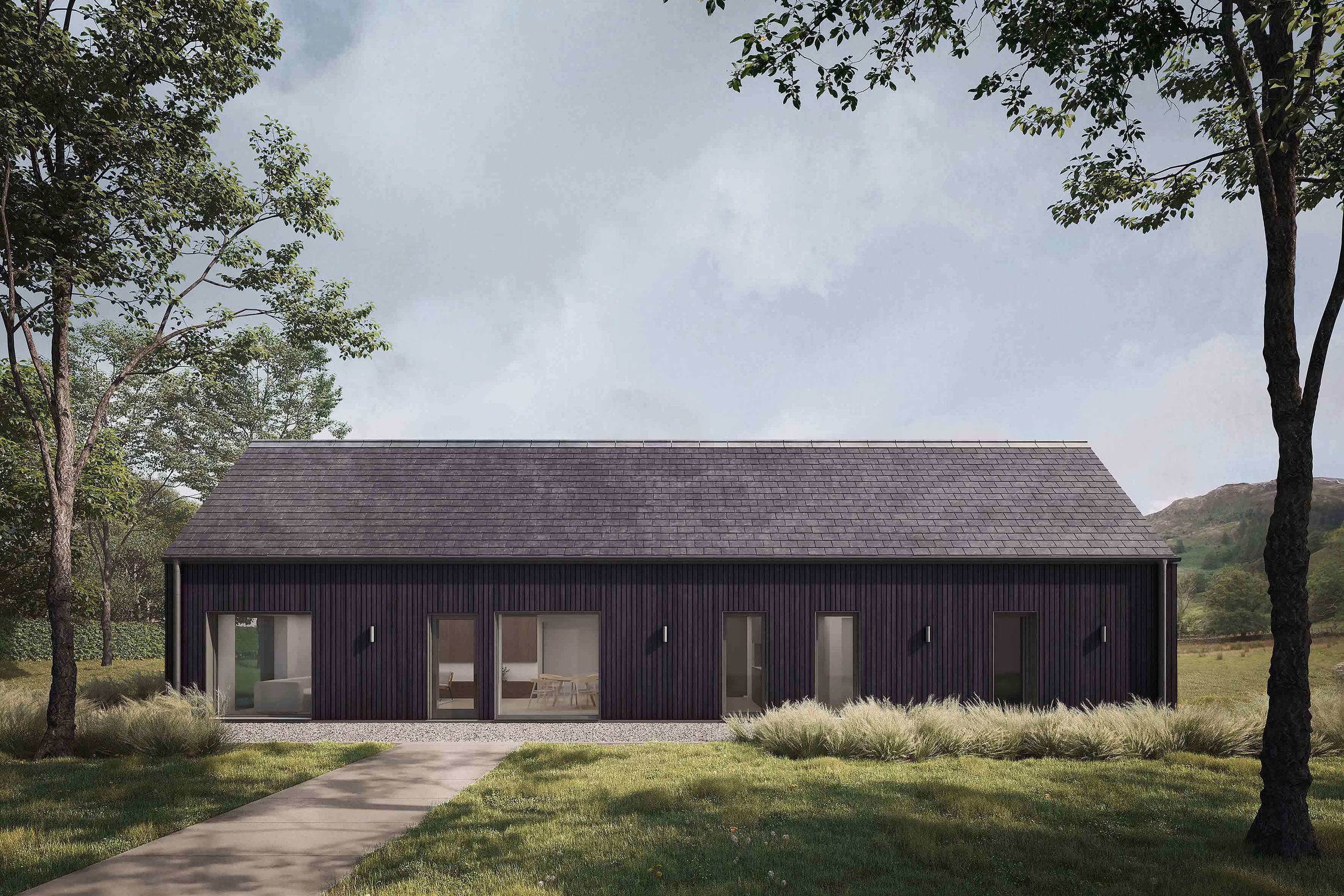 Front on exterior of the Coldwells Build Passivhaus, Argyle. A prefabricated bungalow with black cladding and a grey pitched slate roof.
