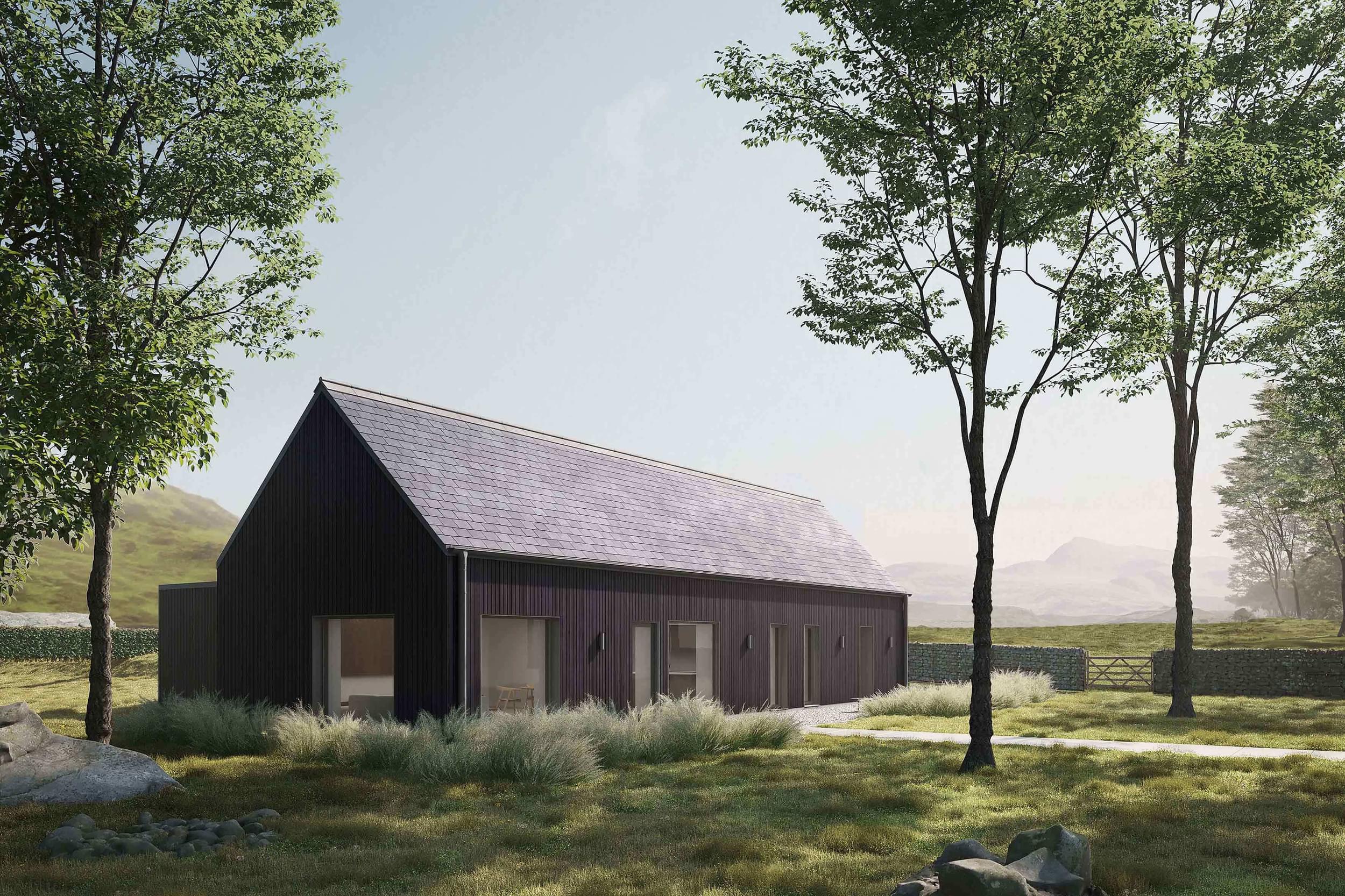 Side exterior of the Coldwells Build Passivhaus, Argyle. A prefabricated bungalow with black cladding and a grey pitched slate roof.