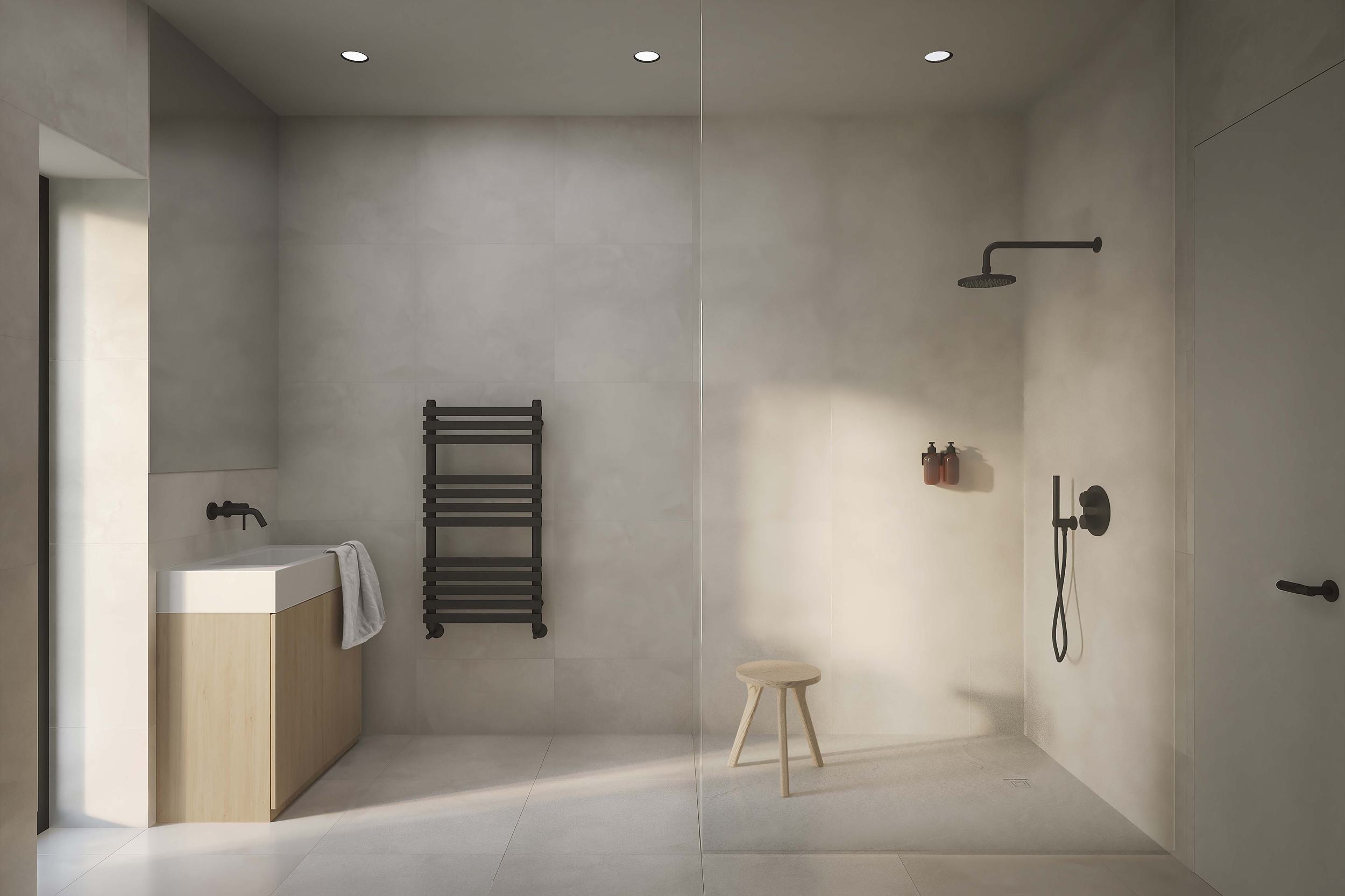 Bathroom of the Coldwells Build Passivhaus. Floor to ceiling tiles with frameless shower and black fixtures.