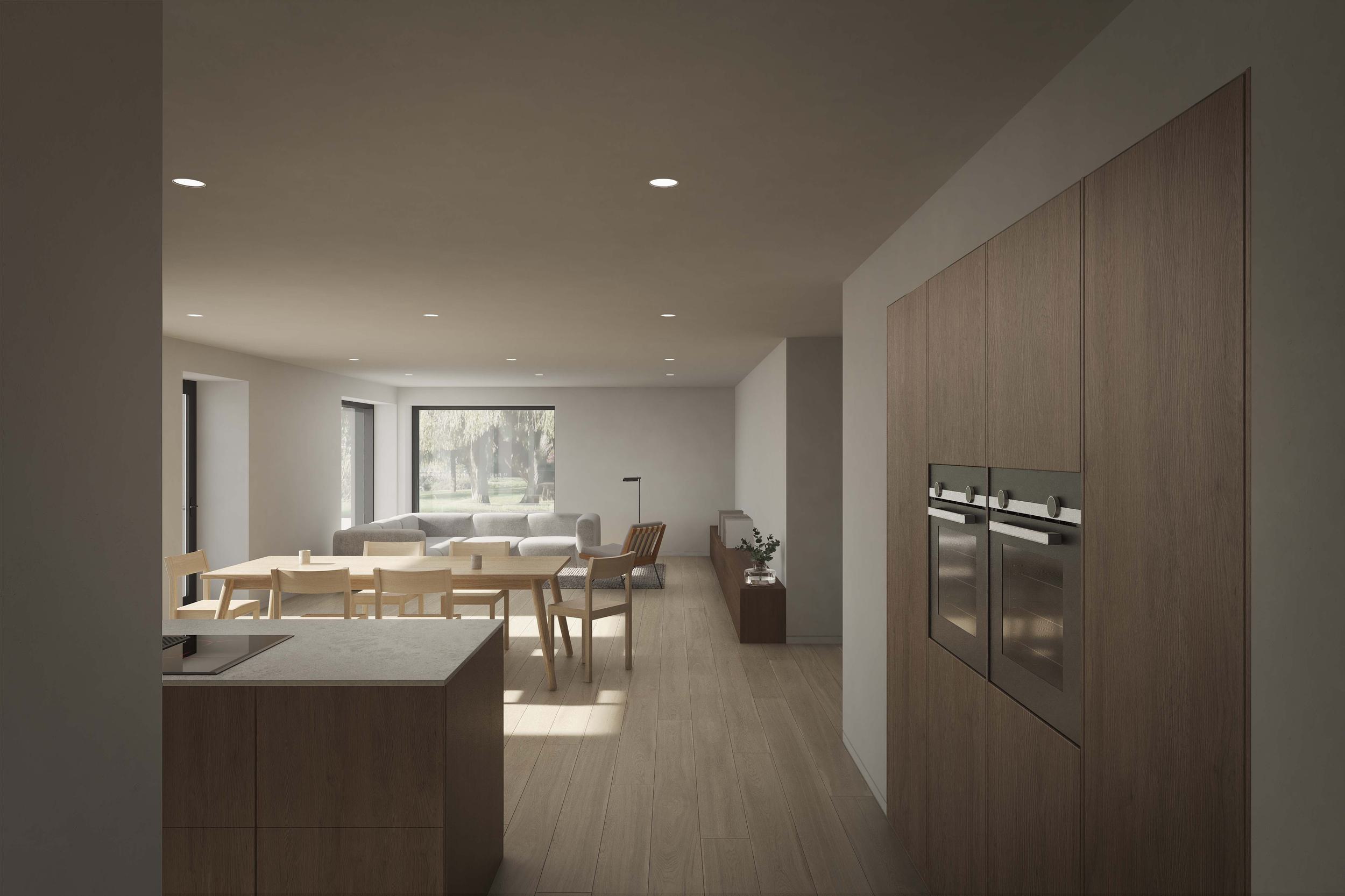 Living space and kitchen of the Coldwells Build Passivhaus, McKinley. Large glazing with an oak circular dining table and sofa area.